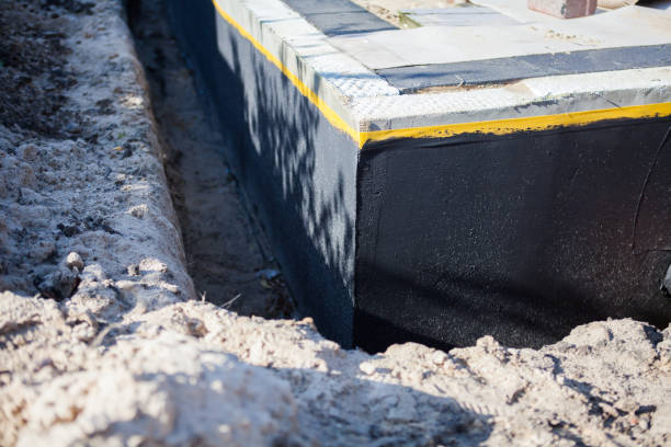 Professional Basement Waterproofing technician working in Victoria, KS